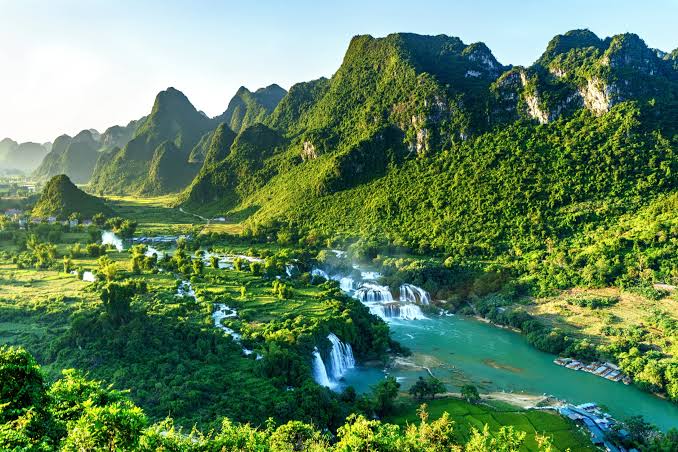 Cascading waterfalls surrounded by lush green Geopark scenery